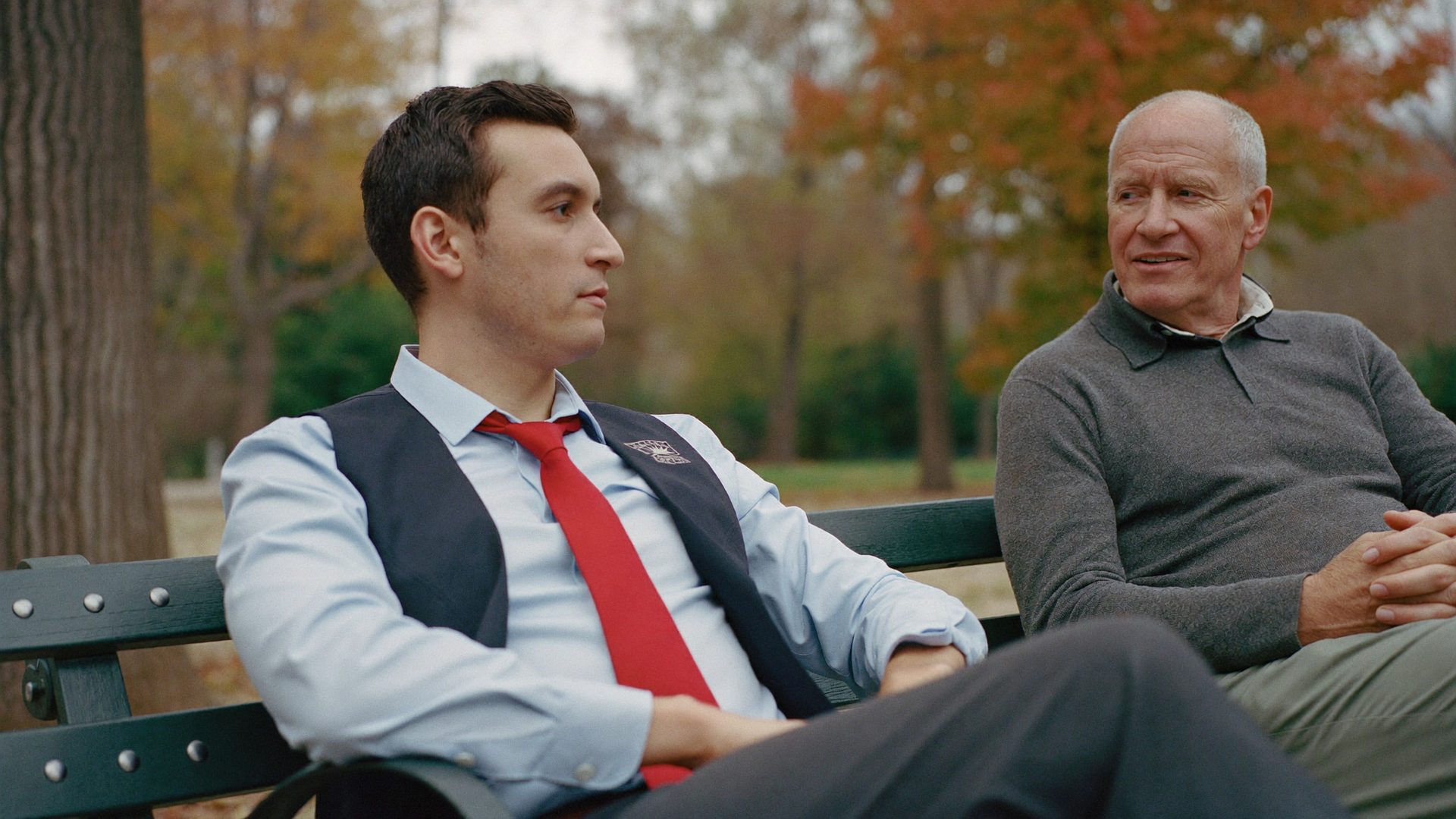 Advisor and older client talking on a park bench