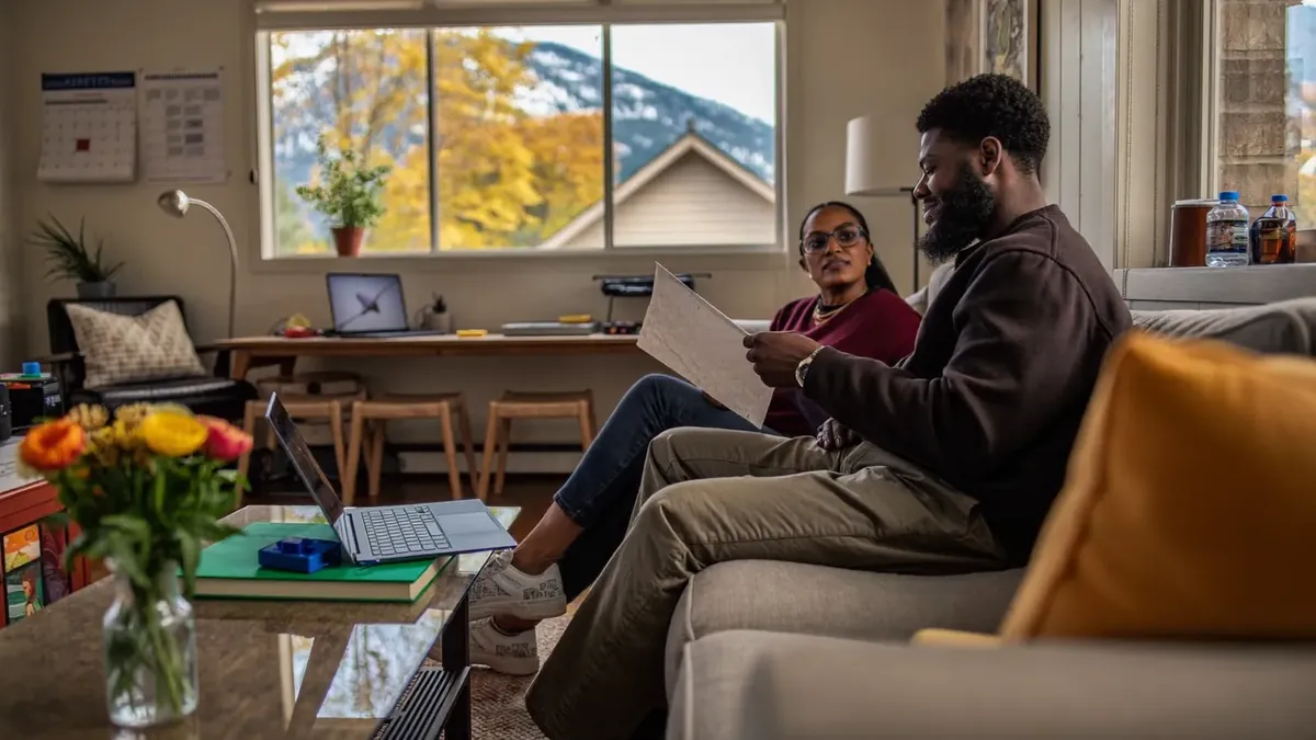 A couple in a cozy Colorado home in autumn planning their coverage together
