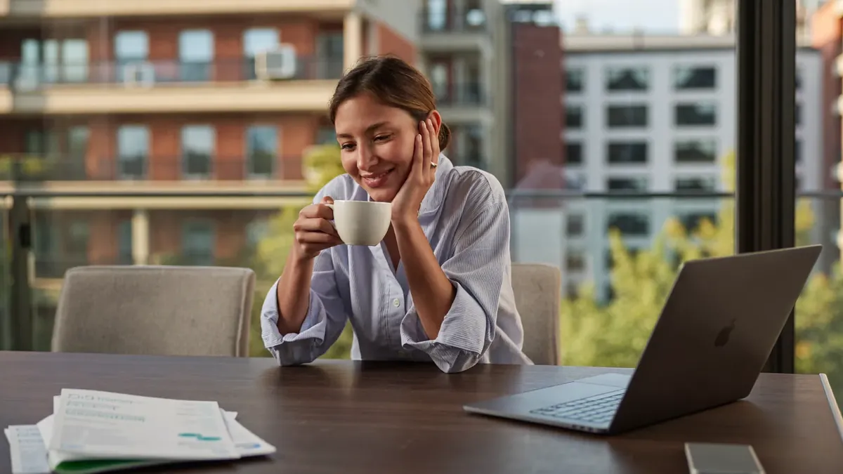 A friendly young insurance advisor helping an adult client choose a health plan in a sunny Colorado office