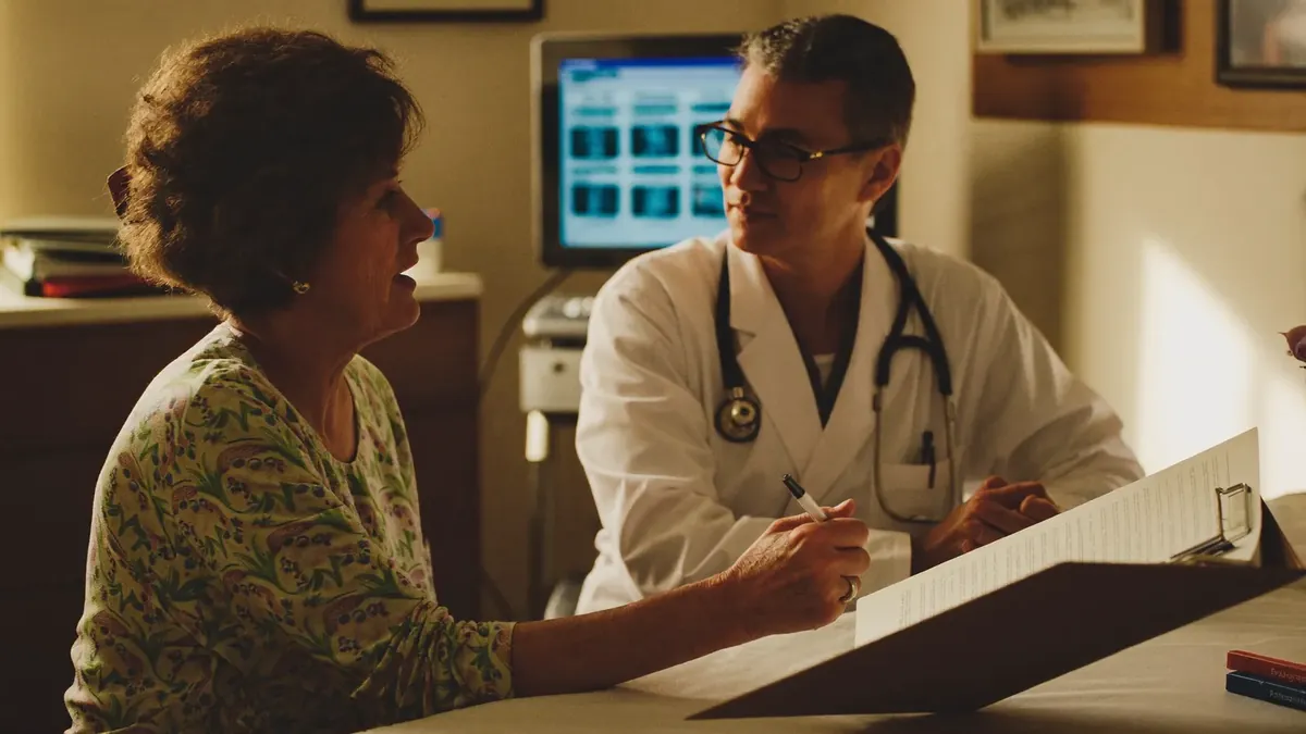 A woman in her fifties talking with a compassionate doctor in a clinic consultation room