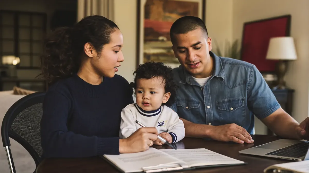 A friendly young insurance advisor helping an adult client choose a health plan in a sunny Colorado office